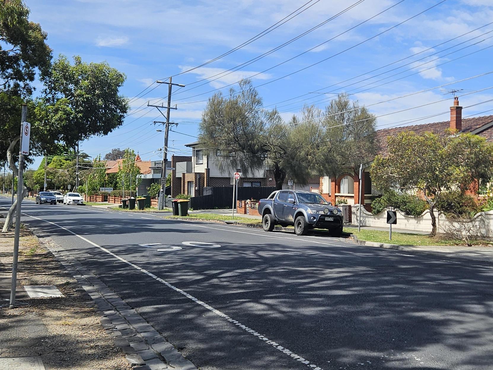 A suburban street with single storey houses along it