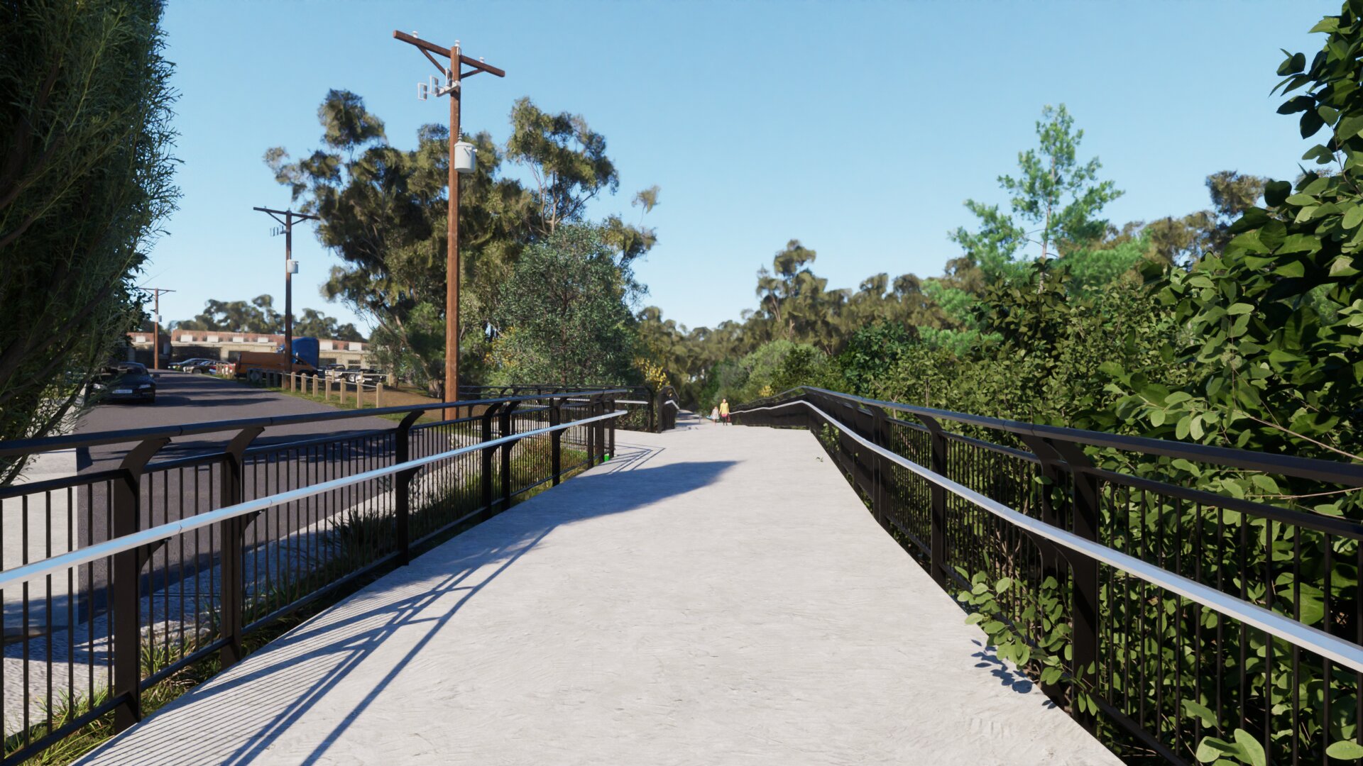A view from the bike path along the Merri creek. There are new fences and railings and a path that turns to the left and leads up to the road.