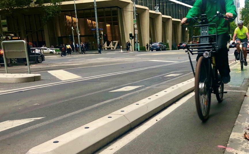 Street with bolt down barriers creating a separated bicycle lane