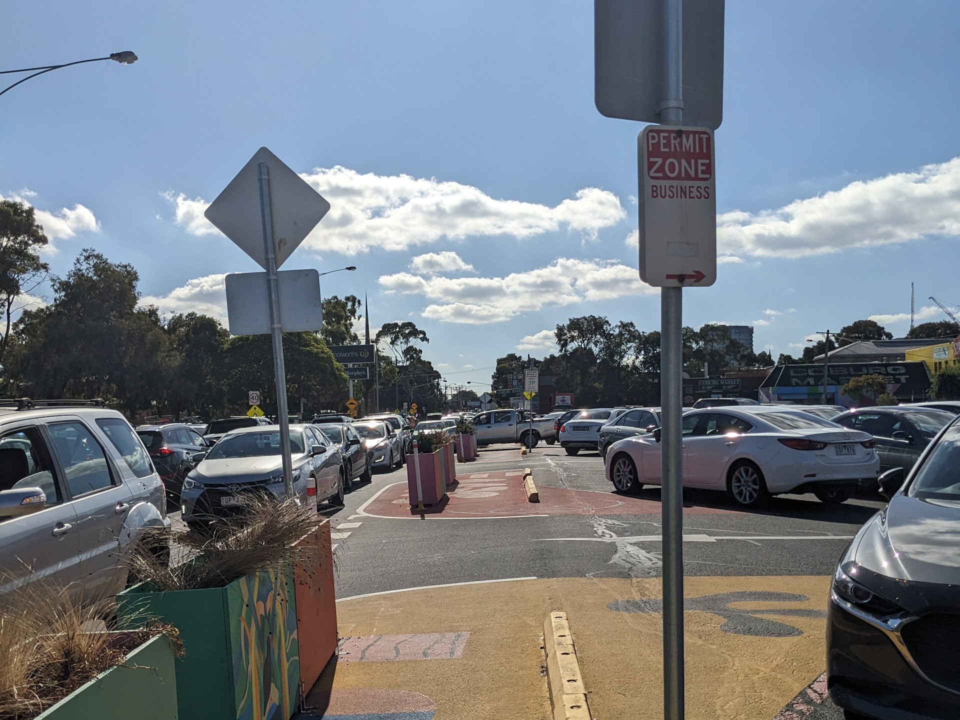 A view looking down Louisa Street, Coburg. There is a car park to the right and street to the left. The walkway is painted on and there are bollards keeping it separated from the road.