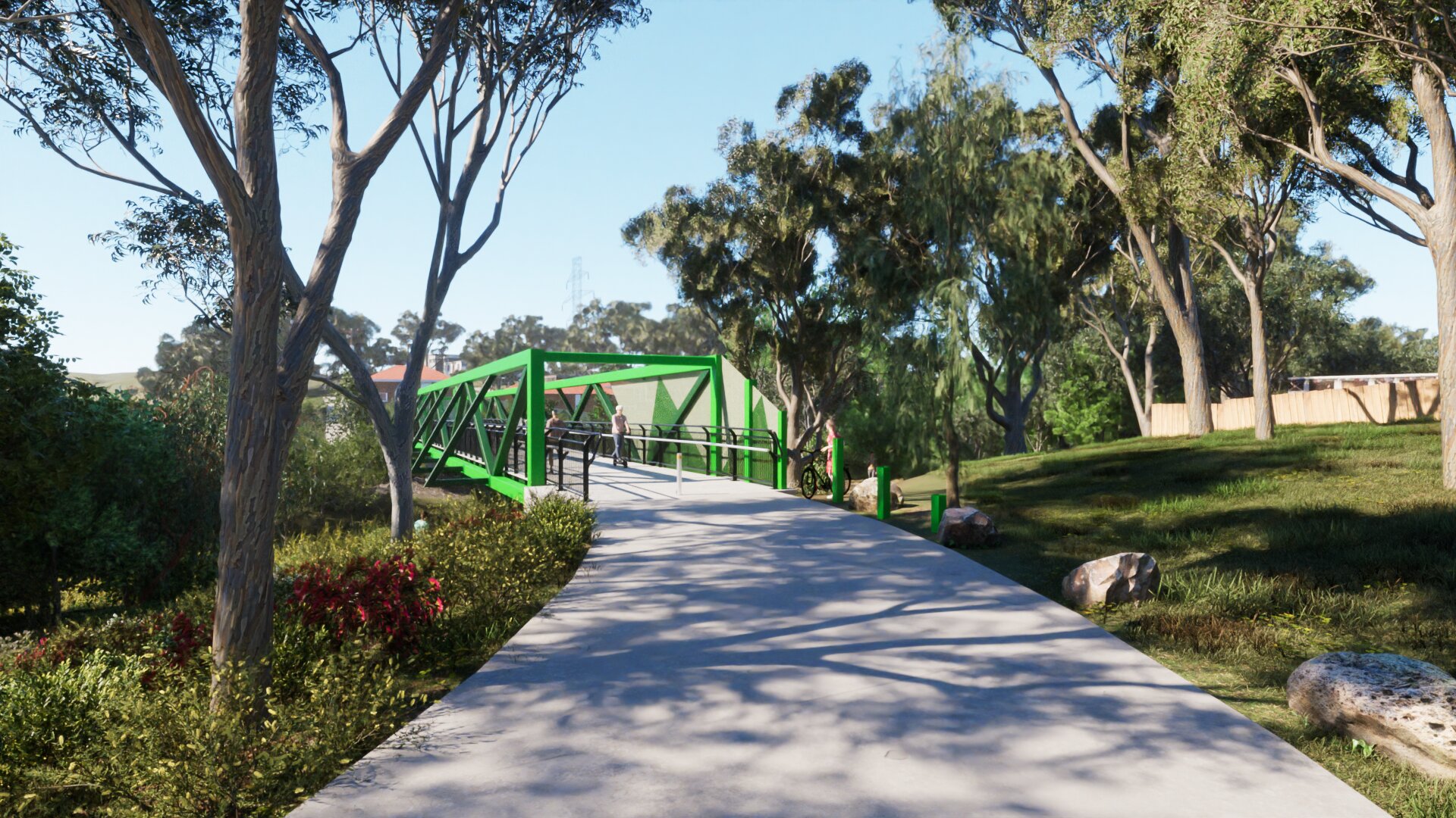 A view standing just in front of the bridge entry on the Harding Street side. there is a path leading up to the bridge. The bridge has green beams that arch over the pathway in a squared of shape. There are railings and fences along the sides of hte bridge.