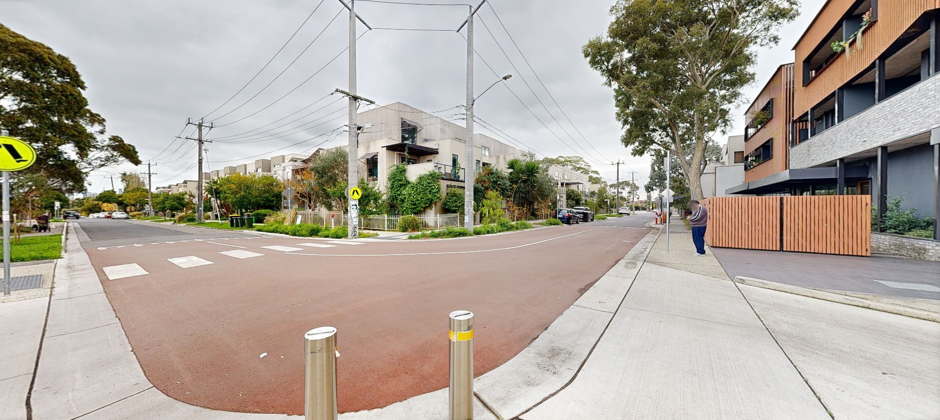 After: A view from the bend in Stewart Street. The road at the corner has a raised section with a zebra crossing. The construction has made way for new housing. 